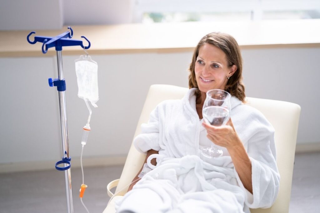 Woman relaxing during IV wellness session highlighting comfort and hydration in vitamin therapy delivery methods.